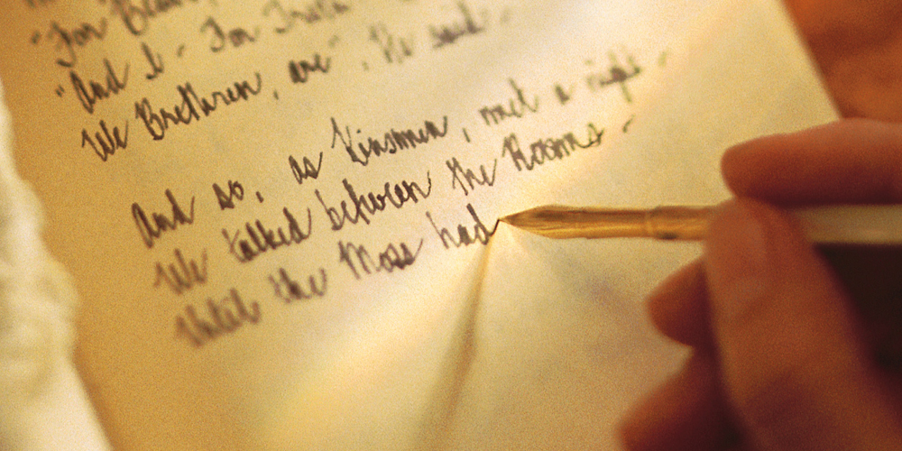 Woman writing in diary with ink pen