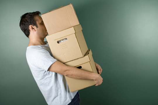 Young man carrying boxes Young man carrying boxes