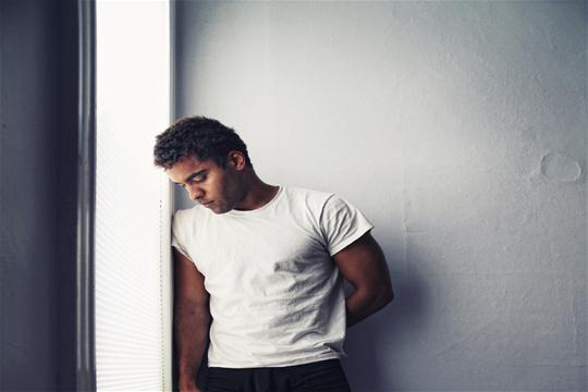 Male standing against the wall
