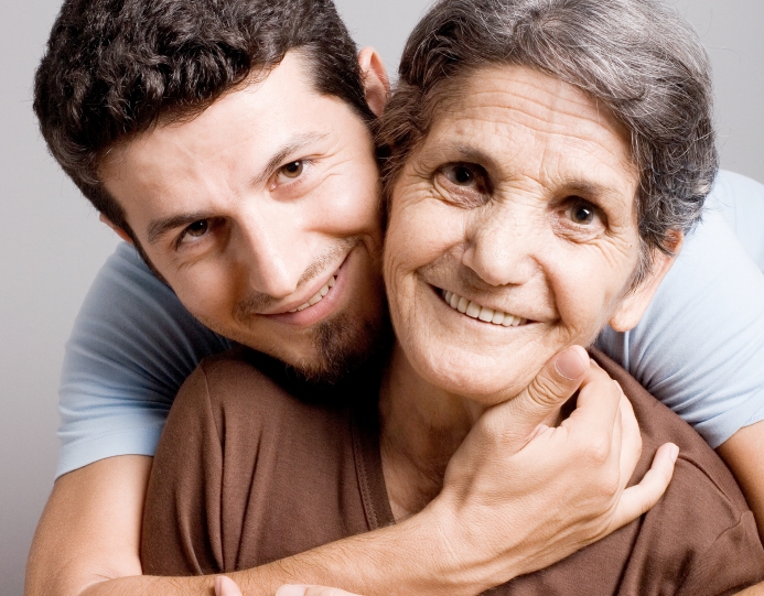 man is hugging her mother