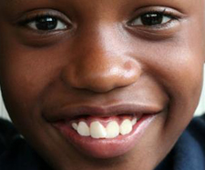 close up of little boy's face smiling at camera